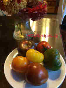 Heirloom Tomatoes used to make Heirloom Tomato Salad Recipe for P2 on table with Dahlias
