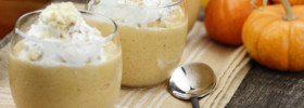 Thanksgiving Holiday Low Carb Pumpkin Whip Dessert with whipped cream, and mini pumpkins